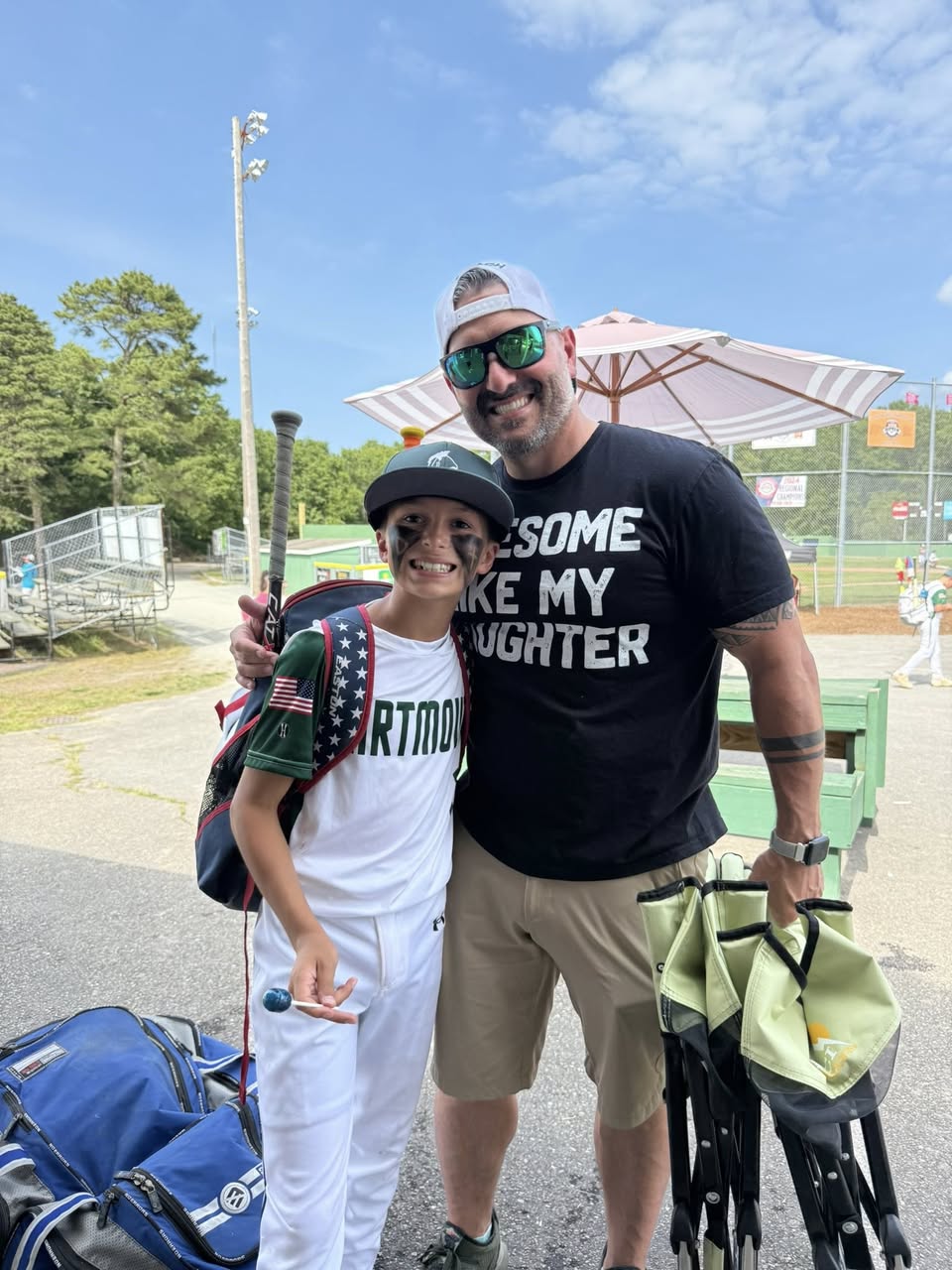 Youth baseball moment between parent coach and child